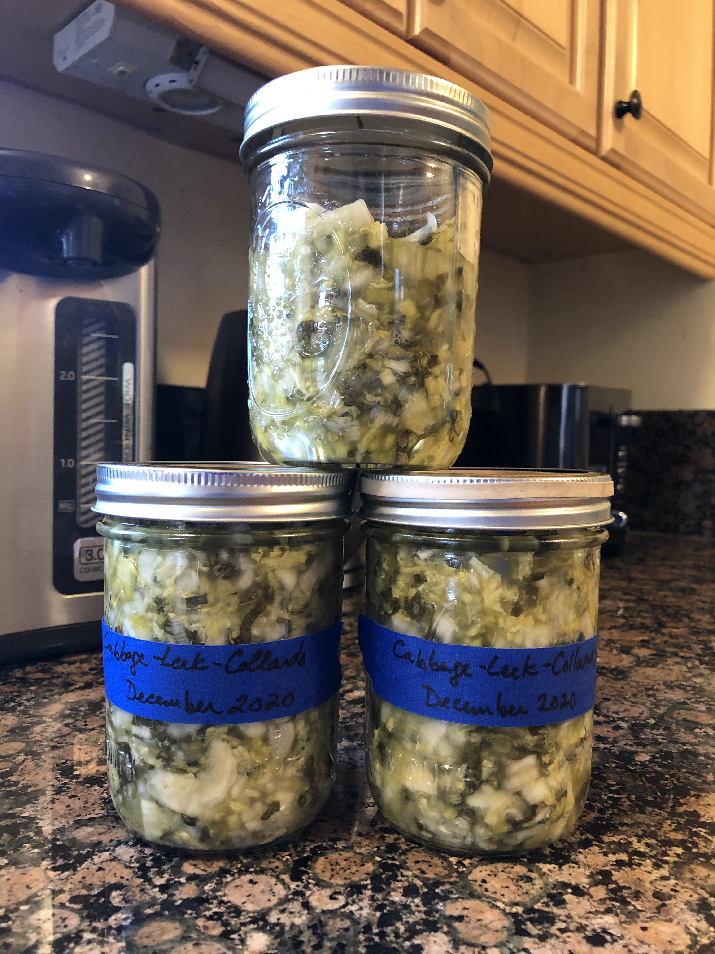 Two and a half wide-mouthed pint jars filled with kraut